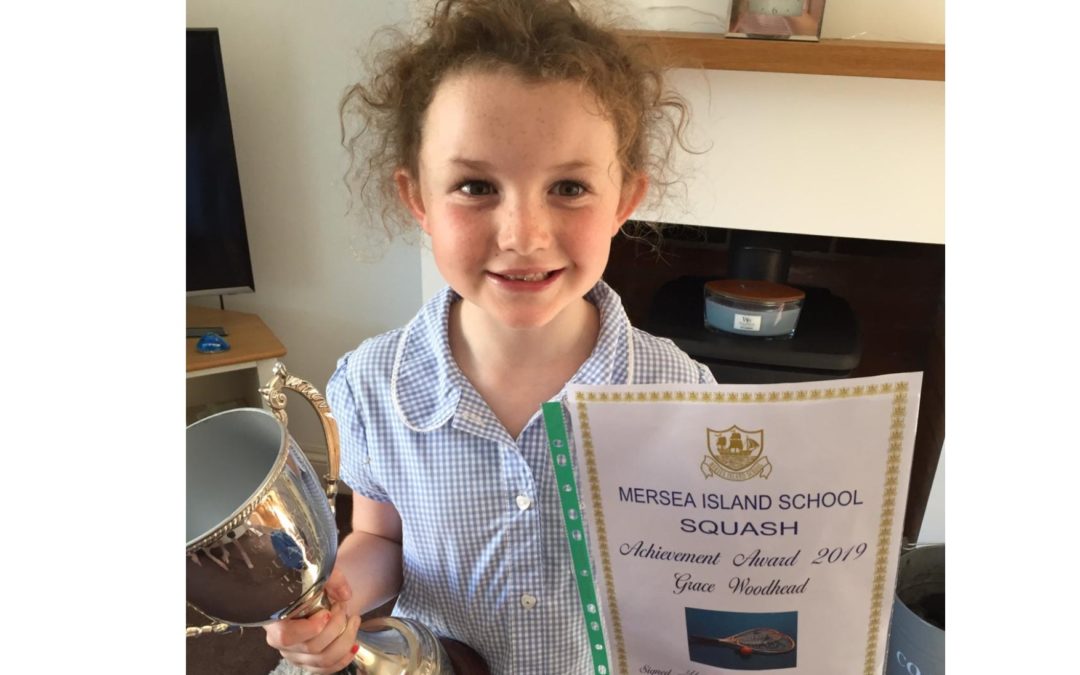 Amazing Grace lifts Mersea School Squash trophy, aged just 7